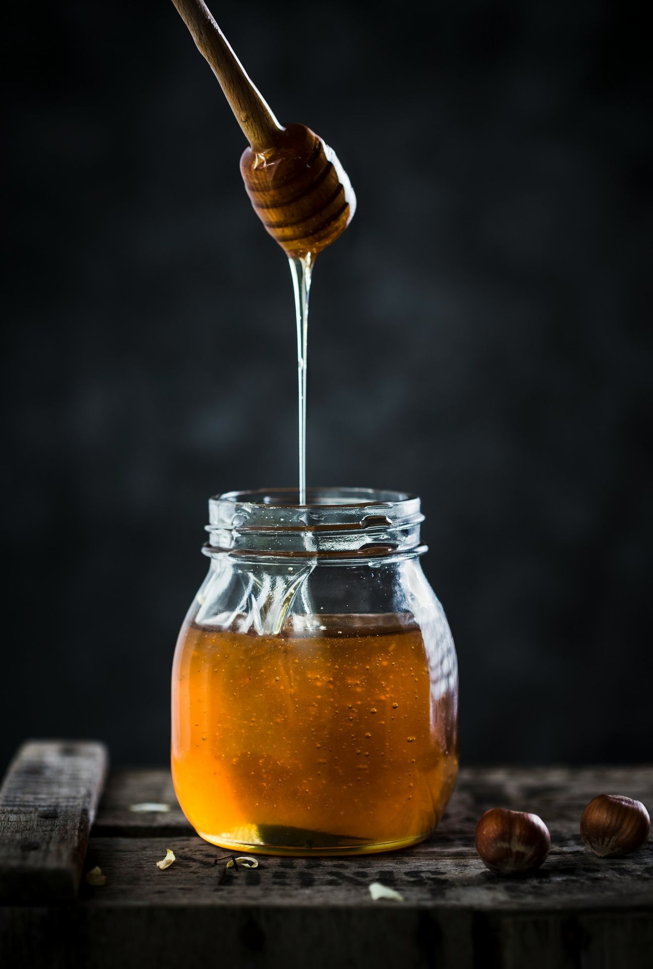 a jar of honey with a wooden spoon